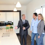 Real estate agent showing modern house to couple