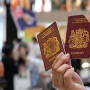 FILE PHOTO: A pro-democracy demonstrator raises his British National Overseas (BNO) passports during a protest against new national security legislation in Hong Kong, China June 1, 2020. REUTERS/Tyrone Siu/File Photo