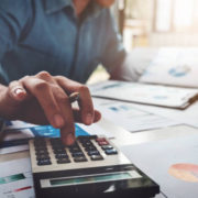 Business accounting concept, Business man using calculator with computer laptop, budget and loan paper in office.